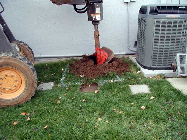 Bobcat with auger starting hole